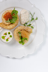 Top view of pancakes with red caviar in a restaurant on a white background. photo for the menu
