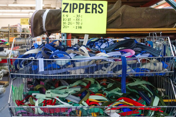 Thrift store bin filled with a variety of zippers