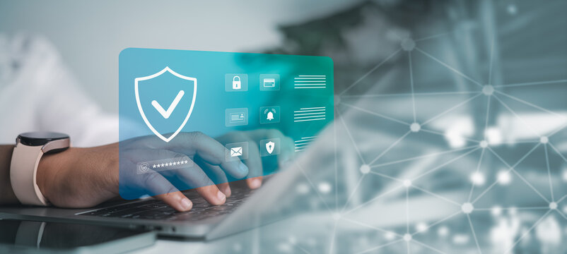 Person is typing on a laptop with a prominent digital security shield and icons for data protection, password, and privacy. Cybersecurity, online data security, personal privacy, network protection.