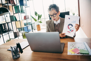 Professional businesswoman presenting analytical charts during a virtual meeting from a modern office workspace