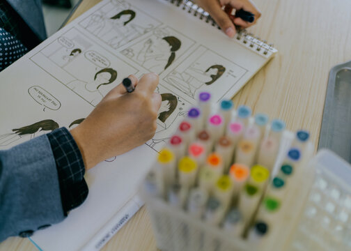 Female artist drawing a storyboard anime comic story.
Manga style.