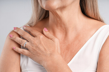 Woman wearing stylish ring on light background, closeup