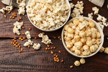 Tasty popcorn and corn kernels on wooden table, flat lay