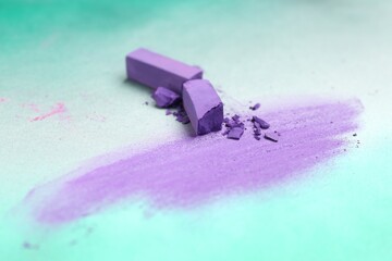 Violet chalk pastels and scribble on color background, closeup