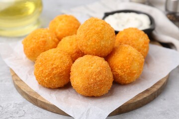 Delicious fried croquette balls on gray table, closeup