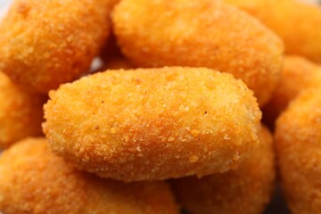 Many delicious fried croquettes as background, closeup