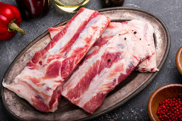 Raw pork ribs chopped on a grey background close up, raw pork meat