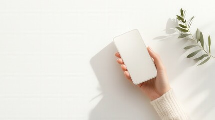 Hand Holding Phone on White Wooden Surface