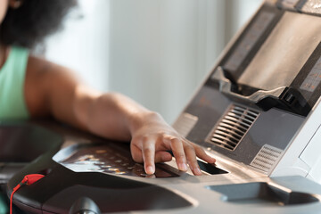 Hands of runner open treadmill machine in gym. Exercising by running indoor concept