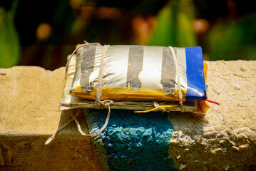 Damaged Lithium Polymer Battery Pack,  Damaged and Swollen Lithium-ion Battery on a Gritty Concrete Floor.