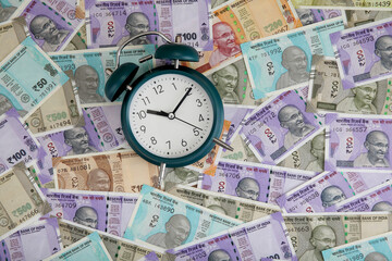 Alarm clock on Indian currency notes