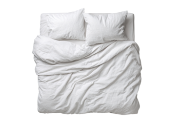 High-angle view of a white bed with rumpled sheets and pillows