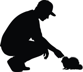 Silhouette of man feeding small animal while squatting, representing kindness, connection with wildlife, and human-animal interaction in nature.