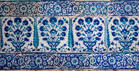 Traditional Ottoman Iznik tile pattern with floral motifs in blue and red colors