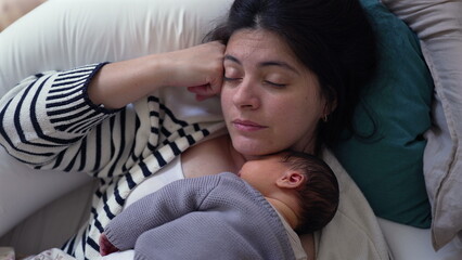 Mother peacefully resting with her newborn baby sleeping on her chest, tender bonding moment in a...