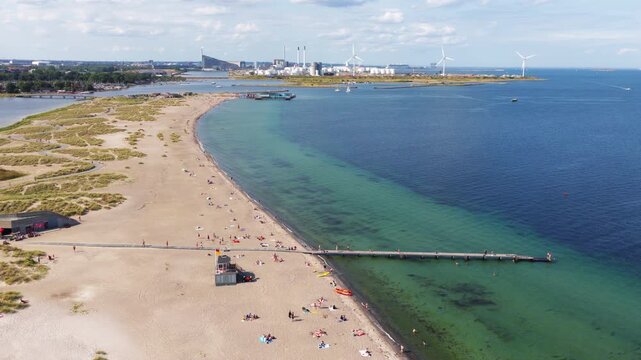 Aerial drone view of Amager Strandpark beach and dunes, with the Copenhagen skyline visible in the distance