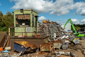 Schrottpresse auf Recyclinghof mit grüner Baggeranlage, Köln, Nordrhein-Westfalen, Deutschland