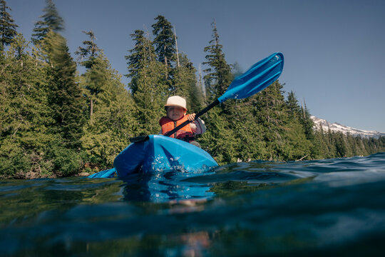 A young toddler swims in an alpine lake in the Pacific Northwest.