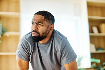 Portrait of a young black man exhausted after exercise in sportswear at home gym