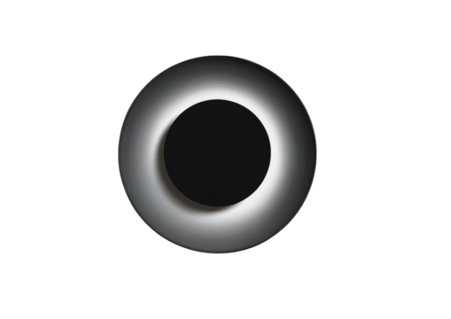 Circular, light-toned ring encircles a dark center.  The ring has a recessed inner edge, creating a layered effect