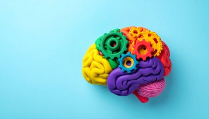 This educational brain model is sculpted from vibrant clay and segmented into clearly defined lobes using bright, contrasting colors—red, yellow, green, orange, and purple. Embedded within the structu