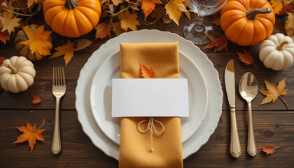 autumn dining table setting with white plate, golden fabric napkin, cutlery tied with rustic string, and blank place card