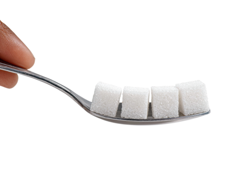 Four sugar cubes on a small metal spoon, held by a hand