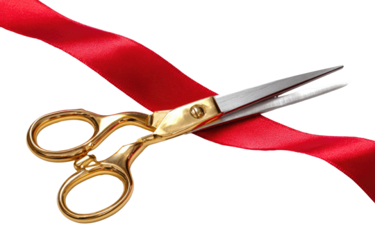Gold-handled scissors cutting a red ribbon