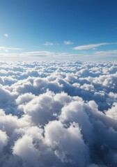 Fototapeta premium An aerial view of fluffy clouds against a bright blue sky, capturing a sense of serenity and vastness