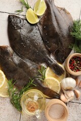 Fresh raw flounder fish and spices on light tiled table, flat lay. Seafood