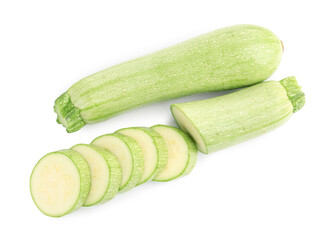 Fresh whole and cut zucchinis isolated on white, top view