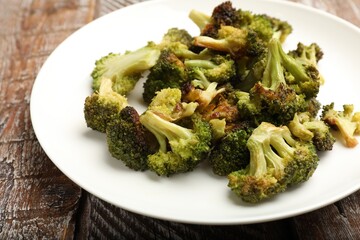 Tasty fried broccoli on wooden table, closeup