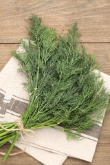 Bunch of fresh dill on wooden table, top view