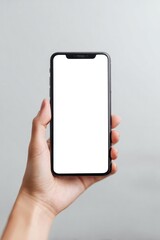 Modern smartphone held up against soft gray background showcasing blank screen