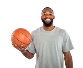 A smiling black man holds a basketball, looking happy and confident in a studio portrait.
