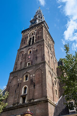 Fototapeta premium Amsterdam Old Church (Oude Kerk), oldest parish church, founded in 1213. Oude Kerk stands in Amsterdam De Wallen district on Old Church's Square (Oudekerksplein). Amsterdam, The Netherlands.