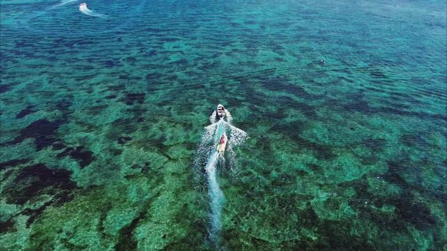 Aerial footage of tourists riding jet skis in Tanjung Benoa, Bali.