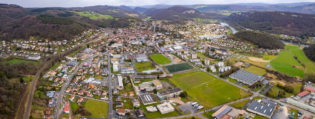 Aerial view of the old town of the city Baume-les-Dames in France on a cloudy afternoon in early spring.