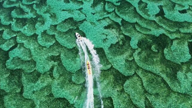 Aerial footage of tourists riding jet skis in Tanjung Benoa, Bali.