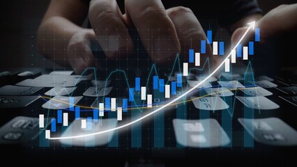 Close-up view of hands typing on a keyboard, enhanced by a financial graph overlay that illustrates growth trends, stock market analysis, and data visualization. Copula