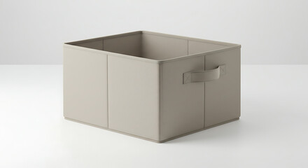 A square beige collapsible fabric storage cube with stitched seams and side handles.