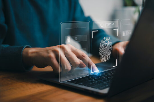 Person uses fingerprint scan on laptop. Digital technology allows identity verification. Use for cybersecurity, tech, or innovation backgrounds. - Powered by Adobe