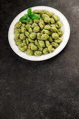 Gnocchi spinach potato dough second course portion size natural product tasty snack fresh delicious gourmet food background on the table rustic top view copy space