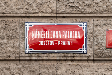 N&aacute;měst&iacute; Jana Palacha (Jan Palach Square) sign in Josefov Praha 1 in Prague, Czechia. Red colored road signage of the location in the so called Jewish Town. Square at the Rudolfinum building.