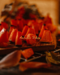 Rustic card with squash pieces on wooden board, lit in soft tones. Magical colours of autumn seasons, mysterious signs, thanksgiving headline for cozy issues and design.