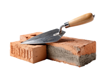 Metal trowel rests on two red bricks, mortar visible
