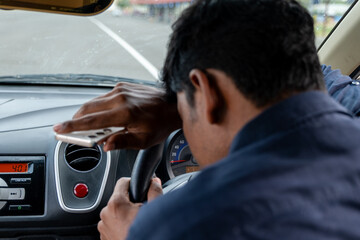 Distracted driver struggling to stay focused while driving