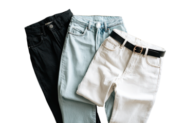 Three pairs of folded jeans, black, light blue, and white, with a dark brown belt on the light-colored pair