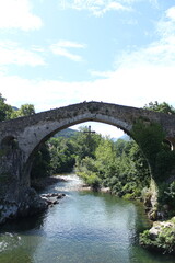 Roman Bridge of Cangas de Onis, historic medieval stone arch bridge over Sella River in Asturias Spain, cultural heritage landmark and famous tourist attraction in northern Spain