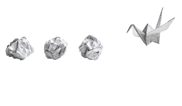 Crumpled paper balls flanking a paper crane